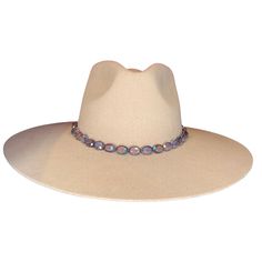 Add sheen to your rodeo look with our hand-crafted deep purple beaded hat band. This hat band features oval beads that adorn the center of the leather band. Crafted from the finest North American deer hides, this hat band is soft, strong, and supple. Due to the self-tie nature of this hat band, it can be adjusted to best fit every cowboy hat in your collection. You can customize this hat band further to your preference by selecting your favorite color of leather band from those offered. This dee Beaded Hat Bands, Purple Hat, Deer Hide, Beaded Hat, Purple Beaded, Purple Hats, Oval Beads, Handmade Hat, Deer Skin