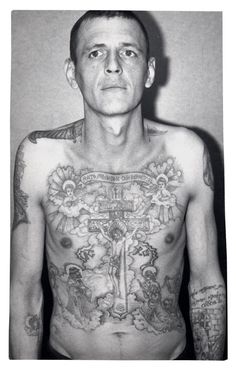 a man with many tattoos on his chest