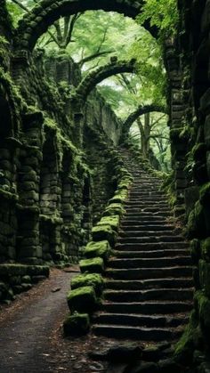 an old stone stairway with moss growing on the walls and steps leading up to it