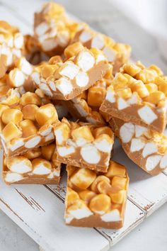 marshmallows and caramel are stacked on top of each other in the shape of squares