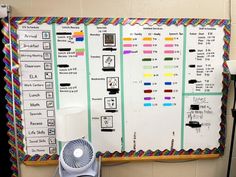 a white board with many different types of wires on it and a fan next to it