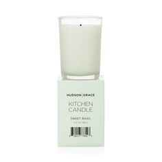 a glass candle sitting on top of a white box next to a barcode label