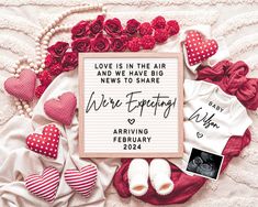 a baby announcement surrounded by hearts, flowers and other things to write on the paper