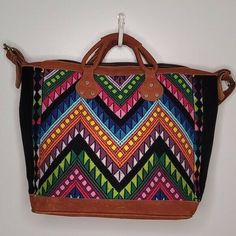 This bag features a vintage huipil of geometric design with all the bright colors! The Large size is 21” L x 15” H x 9" D and very lightweight. The vintage huipil from Chichicastenango, Guatemala was woven by women artisans on a backstrap loom. The interior has a zippered pocket and one exterior zipped pocket. The bag includes removable straps that will convert the bag into a shoulder bag, it has 5 chrome legs. In excellent condition Lv Neverfull Mm, Louis Vuitton Keepall 50, Vera Bradley Travel Bag, Handwoven Bag, Backstrap Loom, Weekend Travel Bags, Crossbody Bags For Travel, Travel Handbags, Louis Vuitton Keepall