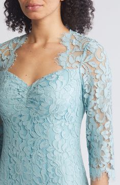 a woman wearing a blue lace dress