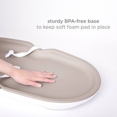 a person's hand is on the edge of a bathtub that has been placed in place