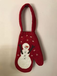 a snowman mitt hanging on the wall