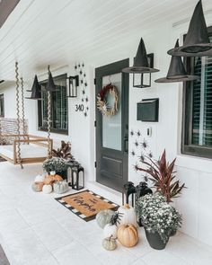 front porch decorated for halloween with pumpkins and witch hats