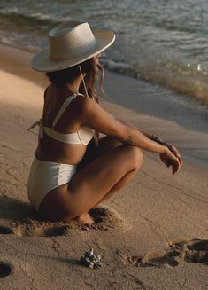 The dreamiest beach hat has arrived. Inspired by white sand beaches you could spend hours shifting through the shells & coral. We took our most popular wool hat style & turned it into summer bliss. A stiff cream straw & a rolled pencil brim, with a teardrop crown. A seashell band attached & a removable matching shell chin strap with gold clasps. Brim- 10 cm Height- 12cm Structure- Stiff IMPERFECT COLLECTION ** This hat is imperfect, featuring slight flaws such as slight marks, dents, blemishes. Winter Headwear, Hat Style, Beach Hat, White Sand Beach, Felt Hat, Wide Brimmed Hats, White Sand, Hat Band, Brim Hat