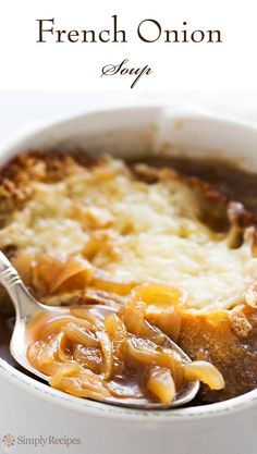 a close up of a spoon in a casserole with meat and cheese on it