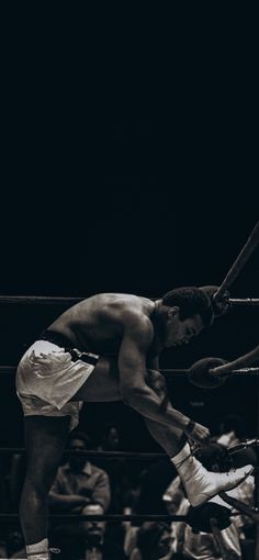 a man standing on top of a boxing ring