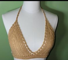 a crocheted halter top on a mannequin