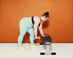 a woman is doing exercises on a treadmill