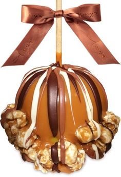 a caramel filled with chocolate and nuts on top of a wooden skewer