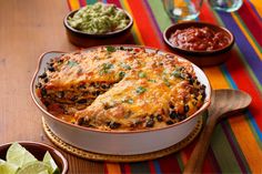 an enchilada casserole with tortilla chips and salsa