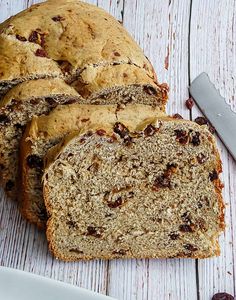 a loaf of bread sitting on top of a table next to a knife and fork