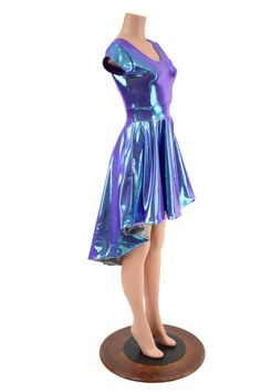 This holographic dress features a double scoop neckline, cap sleeves, a darted bodice and a banded waist.  The hi lo hemline is lined on the skirt portion for a flash of silver holographic sparkle on the underside.Womens Sizing (See below for instructions on where measurements should be taken)XXS: Bust 29"-30" / Waist 22"-23" / Hips 30"-32"Extra Small: Bust 31"-32" / Waist 24"-25" / Hips 33"-35"Small: Bust 33"-34" / Waist 26"-28" / Hips 36"-37"Medium: Bust 35"-37" /Waist 28"-31" / Hips 38"-40"La Summer Costume Party Dress With Asymmetrical Hem, Metallic Summer Dress For Costume Party, Metallic Dress For Summer Costume Party, Summer Metallic Dress For Costume Party, Fitted Iridescent Mini Dress For Spring, Metallic Sleeveless Dress For Costume Party, Spring Fitted Iridescent Mini Dress, Spring Iridescent Fitted Mini Dress, Summer Metallic Dresses With Short Sleeves