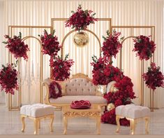 a living room decorated with red flowers and gold furniture