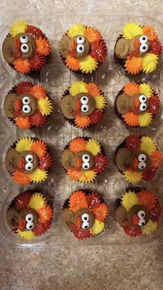 cupcakes decorated to look like turkeys with number 8 on them in a plastic container