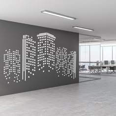 an office with a large city skyline cut out on the wall in front of it