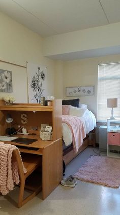 a bed room with a neatly made bed and a desk