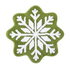 a green and white snowflake shaped rug