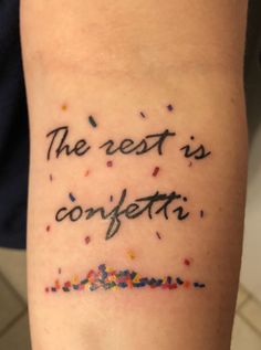 the rest is confetti written on someone's arm with sprinkles