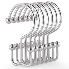 a bunch of metal balls hanging from the side of a rack on a white background