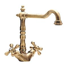 an antique brass faucet with two handles and spouting holes on the side