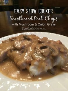 a white plate topped with meat covered in gravy