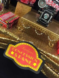 a gold sequined table with red and yellow signs