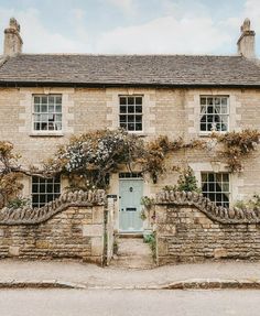 an old stone house with ivy growing on it