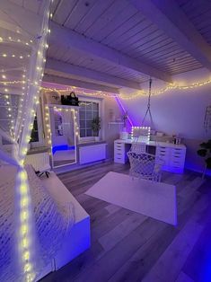 a bedroom decorated in white and purple lights