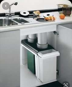 a kitchen sink with an open cabinet underneath it