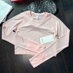 Brand New Tags Lululemon Swiftly Tech Cropped Long Sleeve 2.0 Color Strawberry Milkshake (Stmi/Stmi) Size 10 Please Note I Do Not Accept/Respond To Low Ball Offers Reasonable Offers Only Please And Thank You Guaranteed Authentic 5 Star Top Rated Seller Next Day Shipping G836 Pink Activewear With Thumbholes For Sports, Pink Sporty Activewear With Thumbholes, Spring Activewear With Thumbholes For Sports, Pink Long Sleeve Activewear For Light Exercise, Pink Long Sleeve Activewear For Workout, Lulu Fits, Color Outfits, Athletic Clothes, Lululemon Swiftly Tech