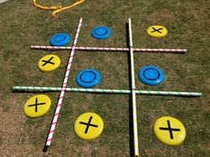 a tic - tac - toe game is shown on the grass in front of a fire hydrant