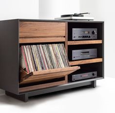 an old record player is sitting on top of a cabinet