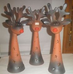 three plastic reindeers with red noses and stars on them