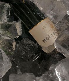 a bottle of wine sitting on top of ice