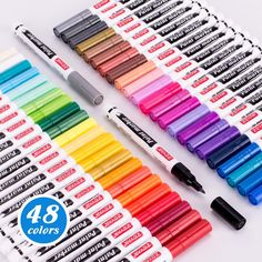 several different colors of markers and pens on a white surface with the words, 48 colors