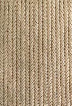 a close up view of the texture of woven fabric, which is beige and white