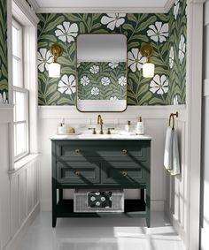 a bathroom with green and white wallpaper, two sinks and a gold framed mirror