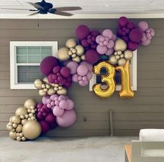 balloons are arranged in the shape of numbers on a house's front porch,