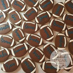 decorated cookies are arranged in the shape of footballs with names and numbers on them