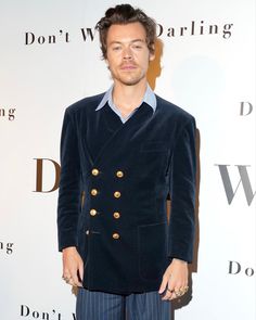 a man standing in front of a white wall