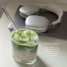 there is a drink with ice and headphones on the table