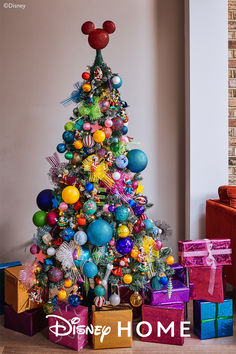 a brightly colored christmas tree with mickey mouse decorations