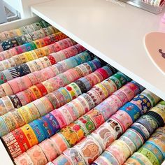 an open drawer filled with lots of different colored tapes