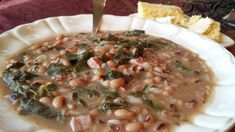 a white plate topped with beans and greens