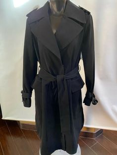 Maximize your look in the maxi silhouette of this long trench coat from London Fog, a water-resistant pick designed with a waist-defining belt. Approx. 45" long   front button closures removable belt Water-resistant; belted Two flap pockets at hip Lined Shell, lining:polyester Machine washable Imported BUST:  44" WAIST:  41" Sleeve length: 26" shoulder to shoulder:   18" across Please Check out my other items! Shipping: Combine shipping is available, please message us when you done your shopping Black Belted Gabardine Outerwear, Belted Black Gabardine Outerwear, Black Gabardine Long Coat, Black Gabardine Outerwear For Fall, Black Belted Business Outerwear, Black Belted Outerwear For Business, Long Trench, Long Trench Coat, Trench Jacket